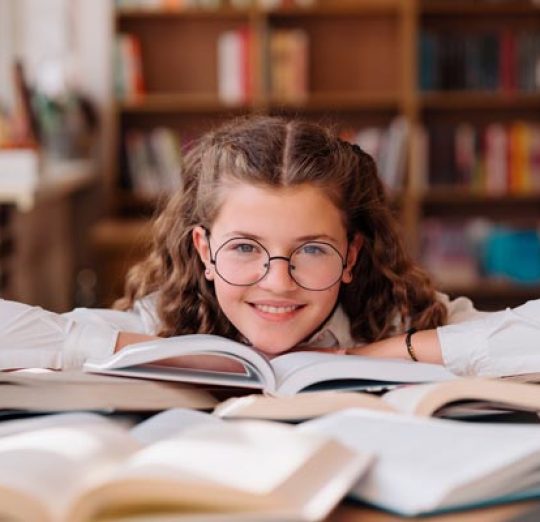 girl-studying-among-books-sitting-at-the-desk-amon-2022-01-12-00-49-58-utc